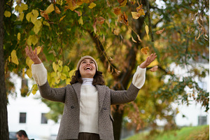 Happy woman throwing fallen autumn, a Beauty & Fashion Photo by HalfPoint