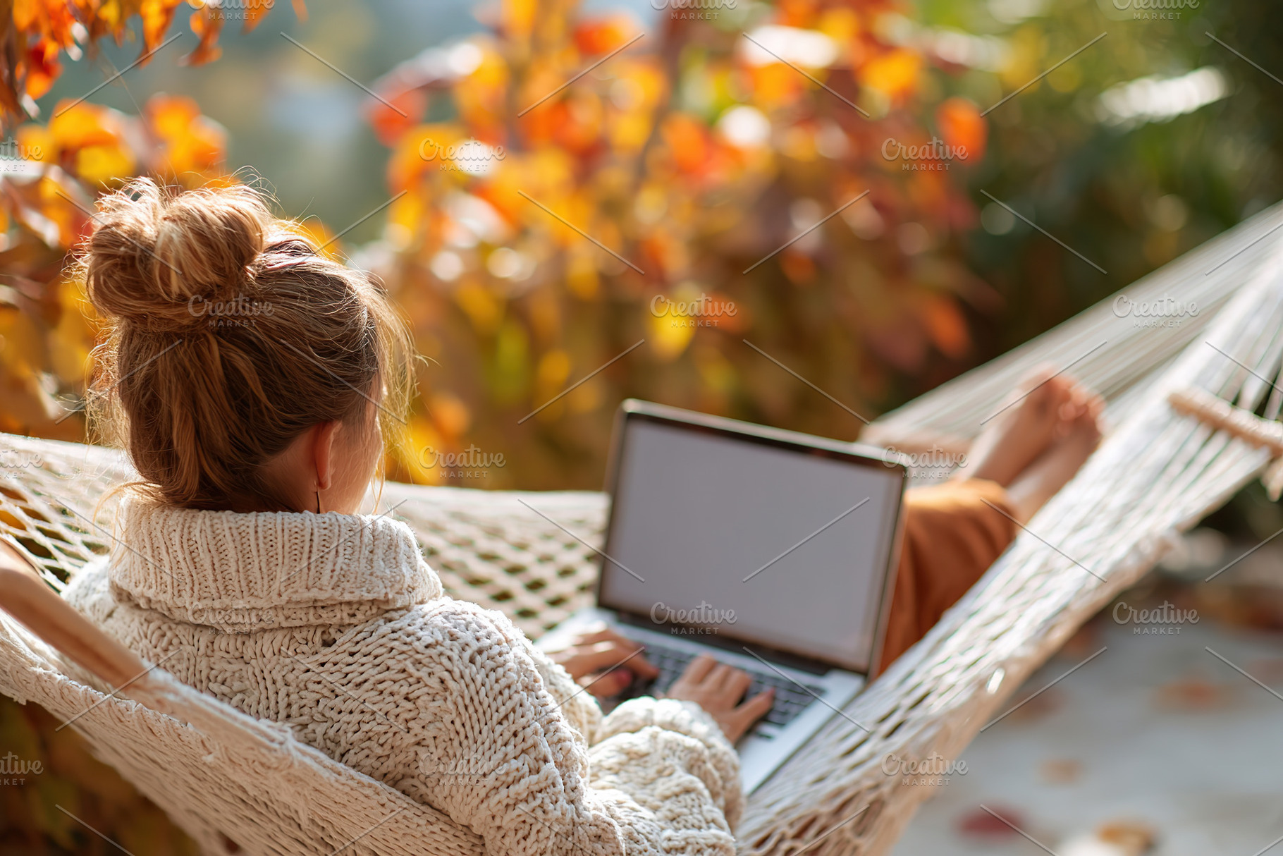 Woman relaxing on hammock with laptop during autumn afternoon in a cozy environ, a Person Photo by AlyaAnd