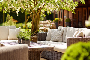 Outdoor wicker sofa and lounge furniture on a patio creating a r, a Photo by Studio ANNA
