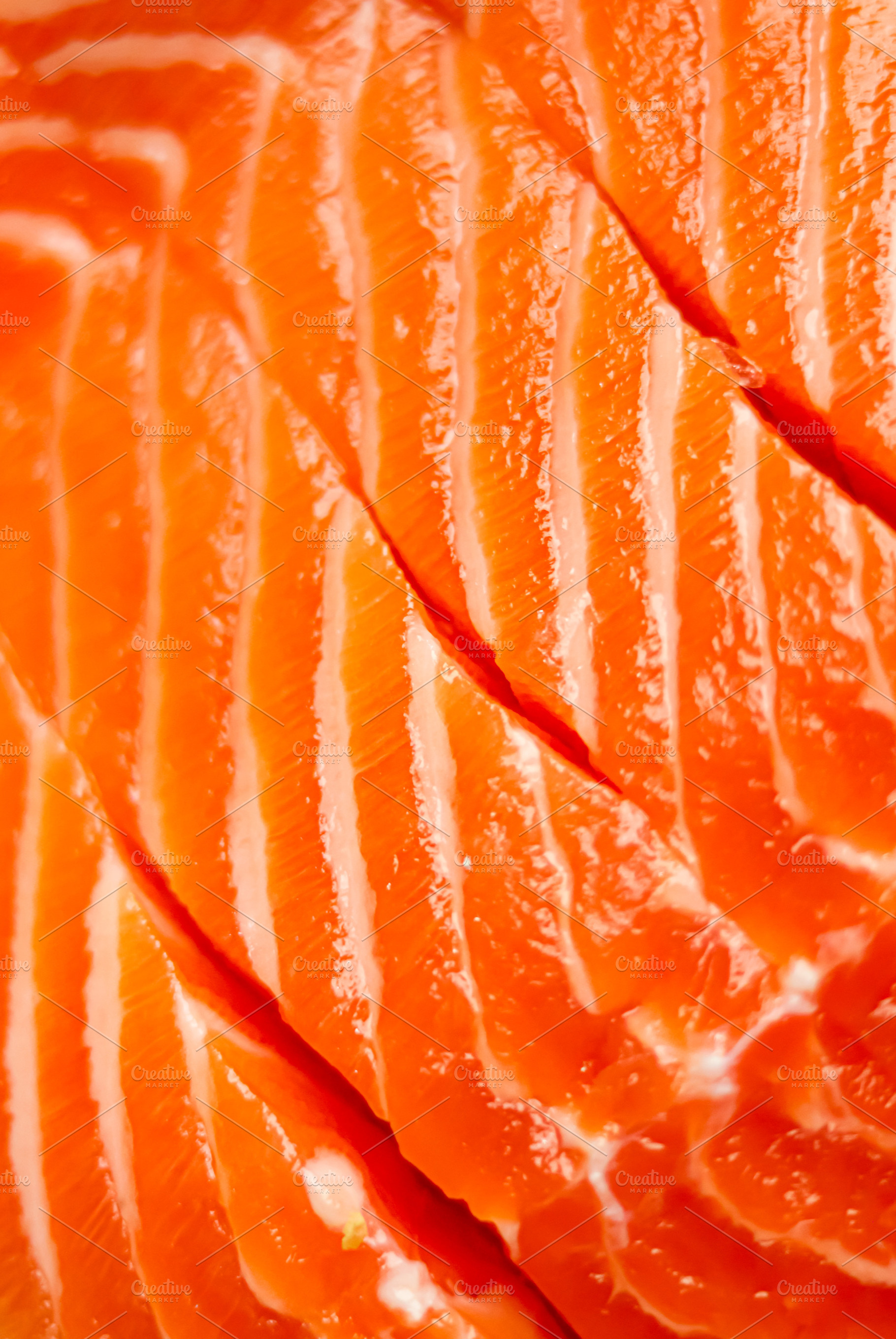 Raw salmon fillet with vibrant orange flesh and white fat lines,, a Photo by Studio ANNA