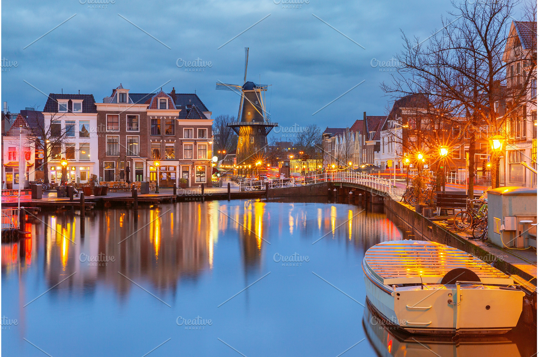 Windmill and canal houses in Leiden, an Architecture Photo by kavalenkava