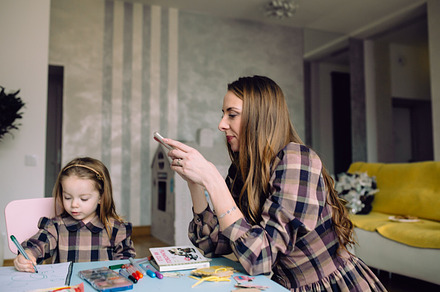 Happy little girl drawing at home with mom containing adorable, attractive, a Person Photo by Tekso