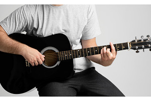 Man with a guitar in hands playing a, a Person Photo by volodymyrshtun13795