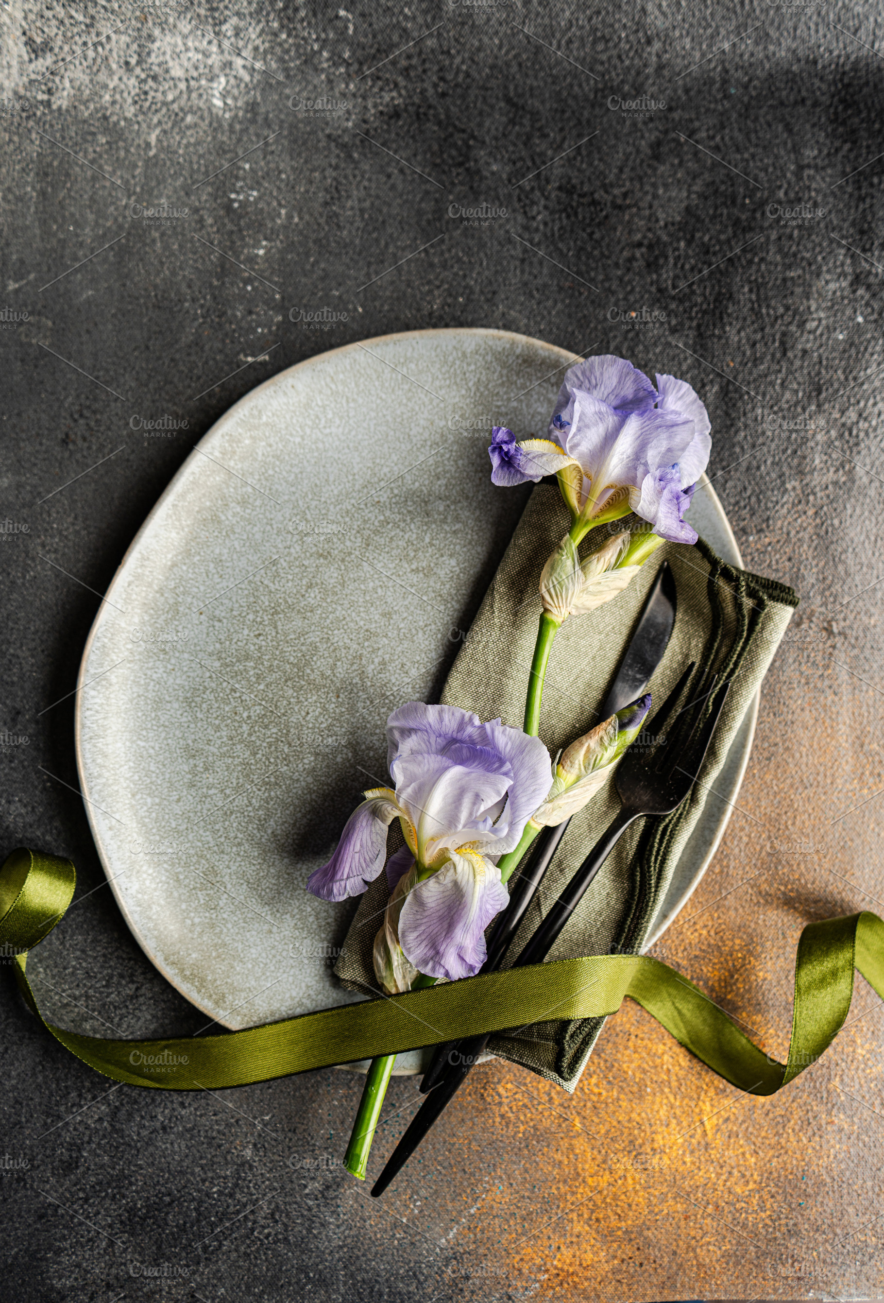 Table setting with pale blue iris flowers, a Food & Drink Photo by Anna Bogush