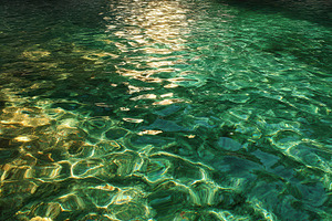 Sunlight shines on clear water, a Photo by Pavel_design