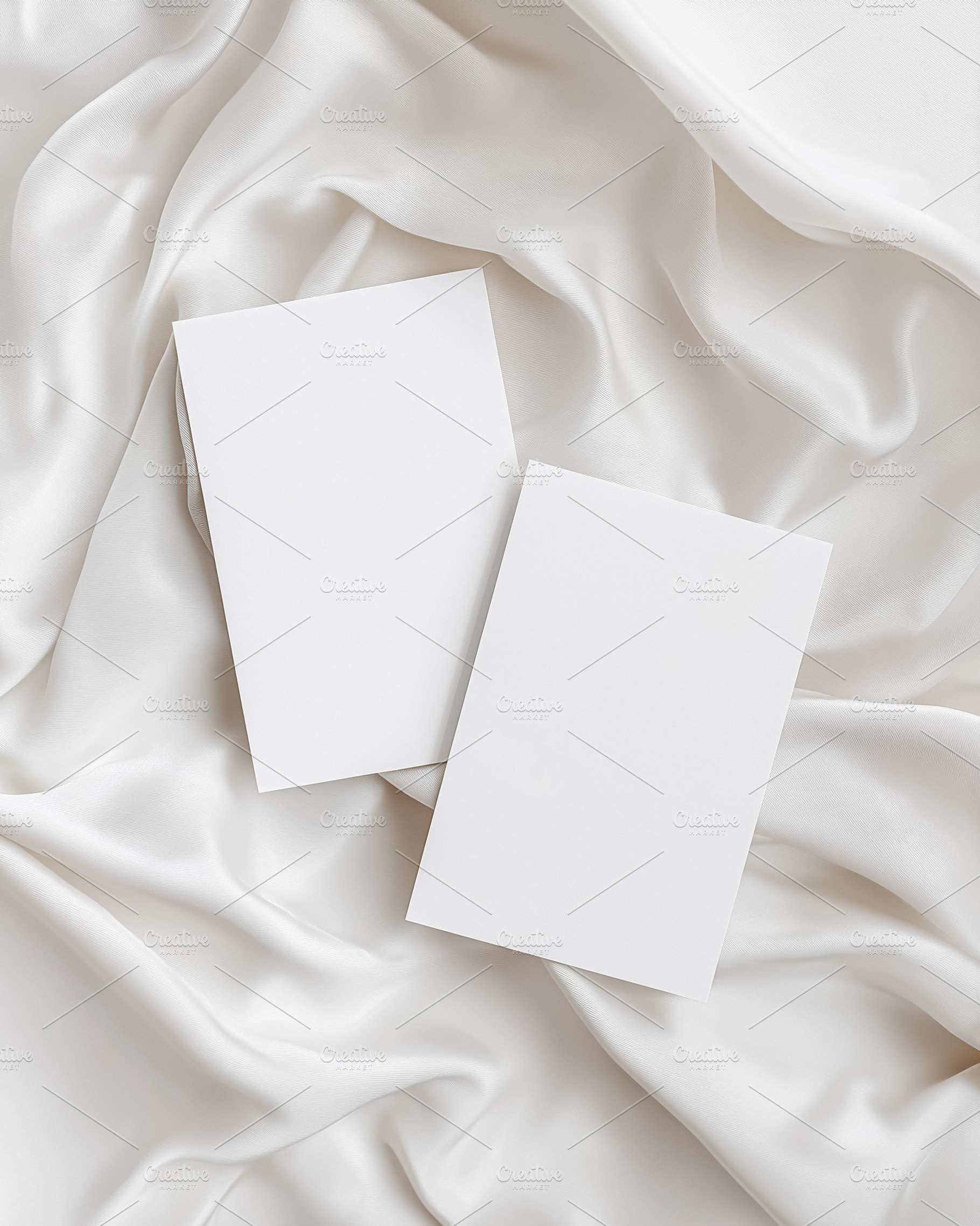 Two clean white paper cards resting on creamy draped silk, creating a beautiful, a Holiday Photo by Studio ANNA