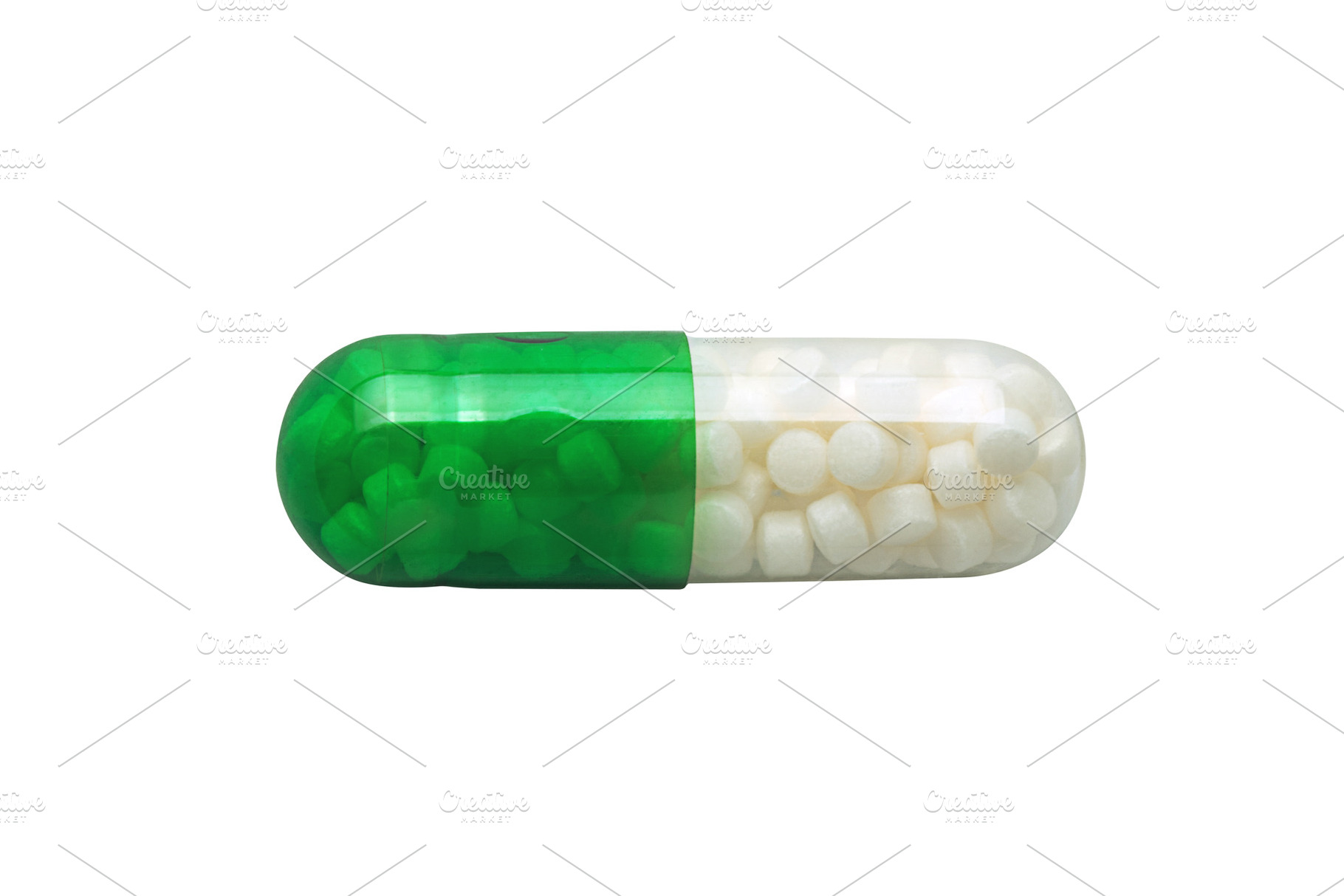Close-up of a green and white capsule filled with small pellets,, a Health & Medical Photo by Ales Munt