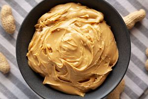 Organic Creamy Peanut Butter in a Bowl, top view., a Food & Drink Photo by LiudmylaChuhunova