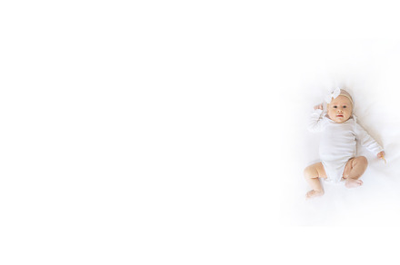 A newborn baby lies on a white bed, a Person Photo by yanadjana