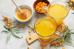 Sea buckthorn hot drink with honey promoting wellness, a Food & Drink Photo by Olena Rudo