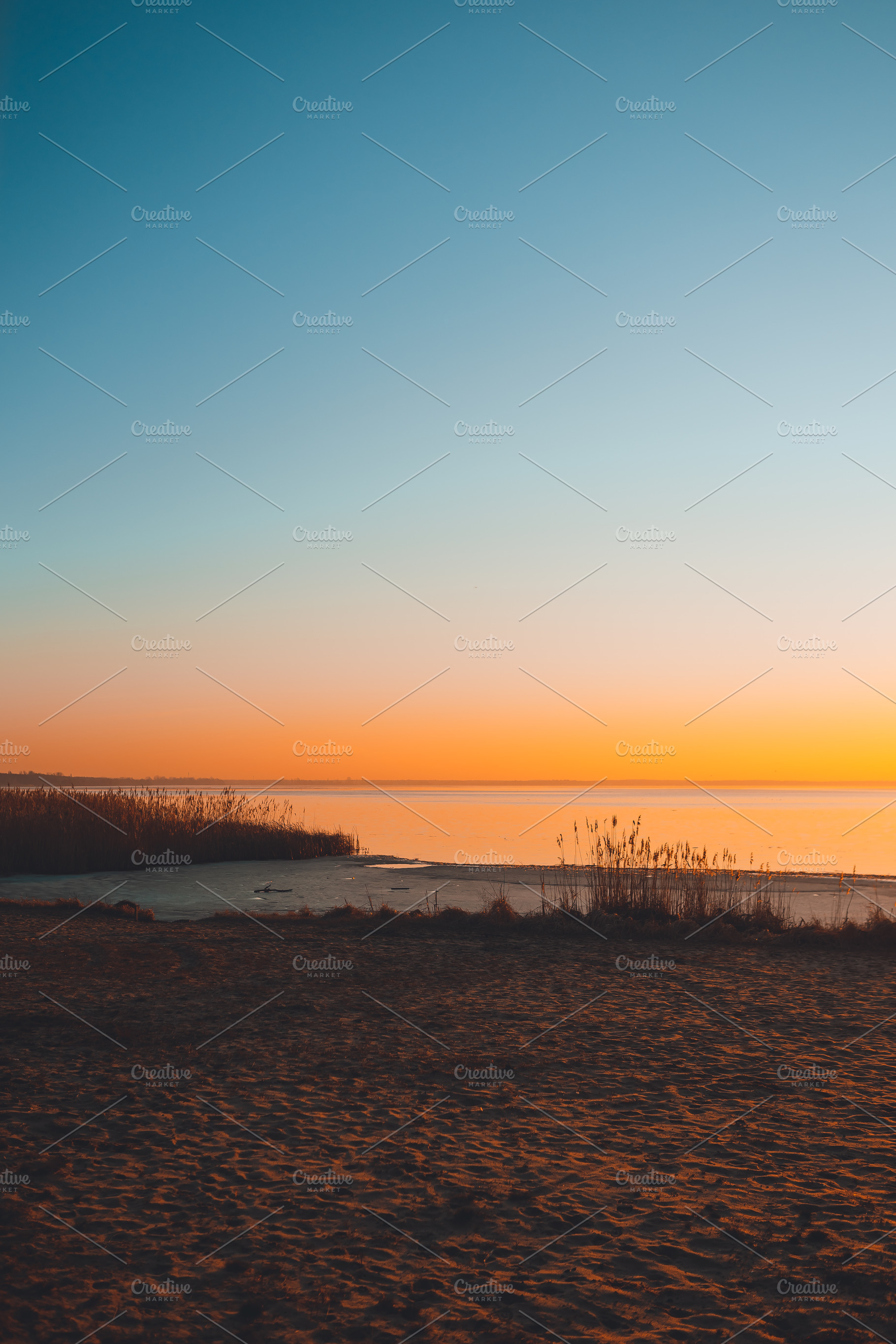 Colorful sunset on the lake containing sunset, sky, and sun, a Nature Photo by Valeryia P.