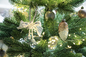 Christmas tree decorating with festive ornaments and lights, a Holiday Photo by Olena Rudo