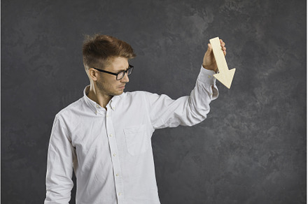 Sad businessman holding arrow that's, a Business Photo by StudioRomantic
