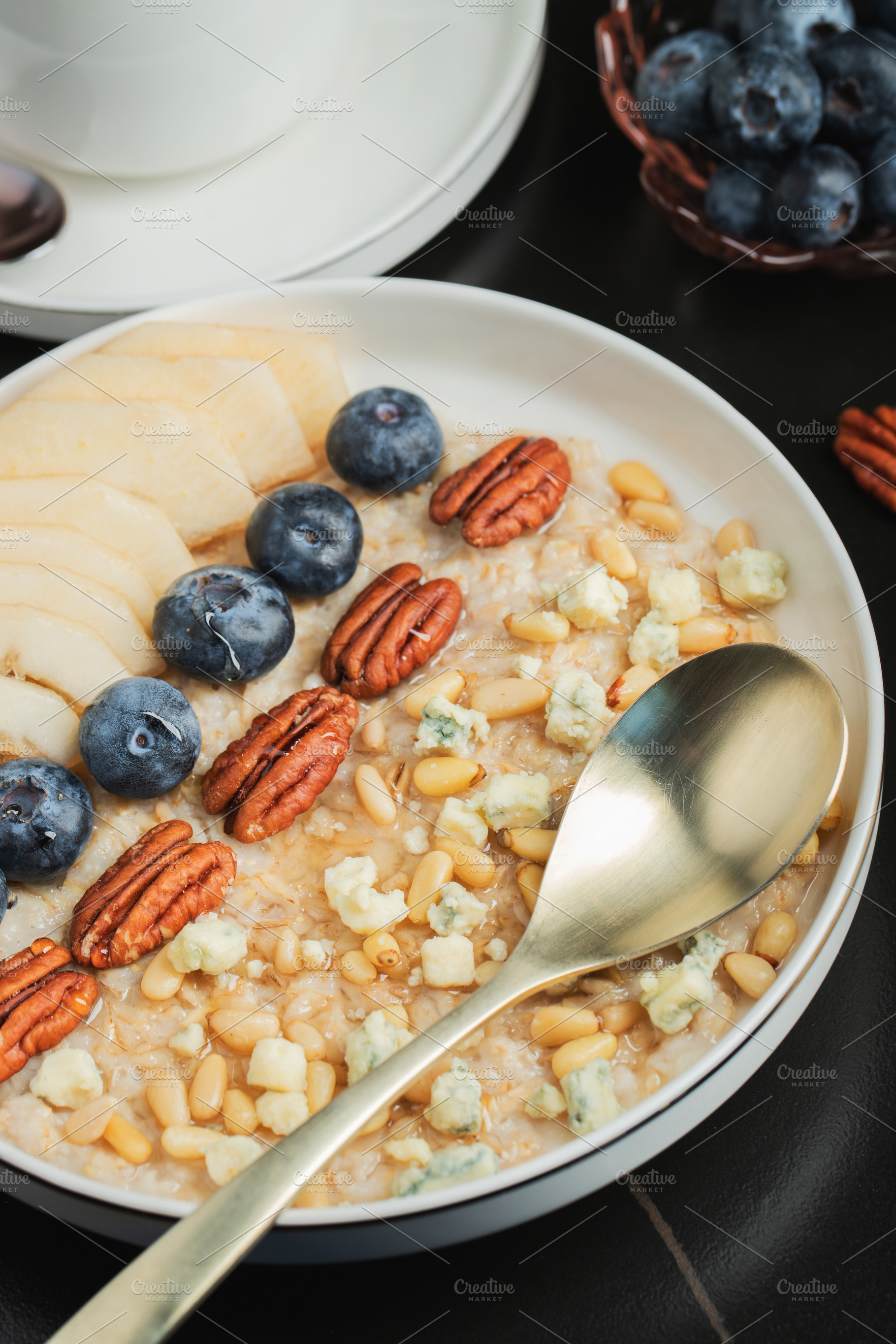 Oatmeal. Bowl of oatmeal porridge with blackberry, bananas and chia seeds on gr, a Food & Drink Photo by Budarinphoto