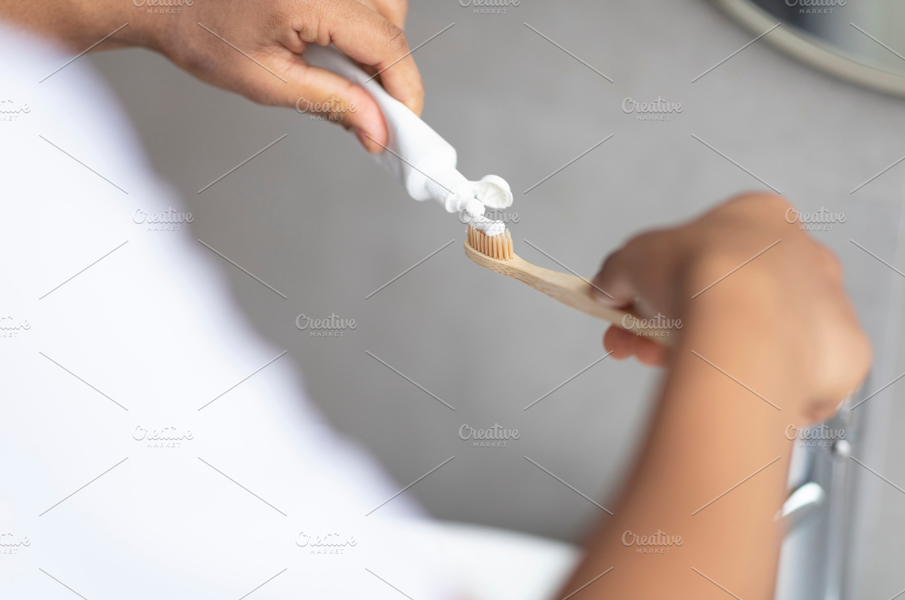 Daily dental care. Male hands pouring toothpaste on toothbrush, enjoying dental, a Person Photo by Prostock-Studio