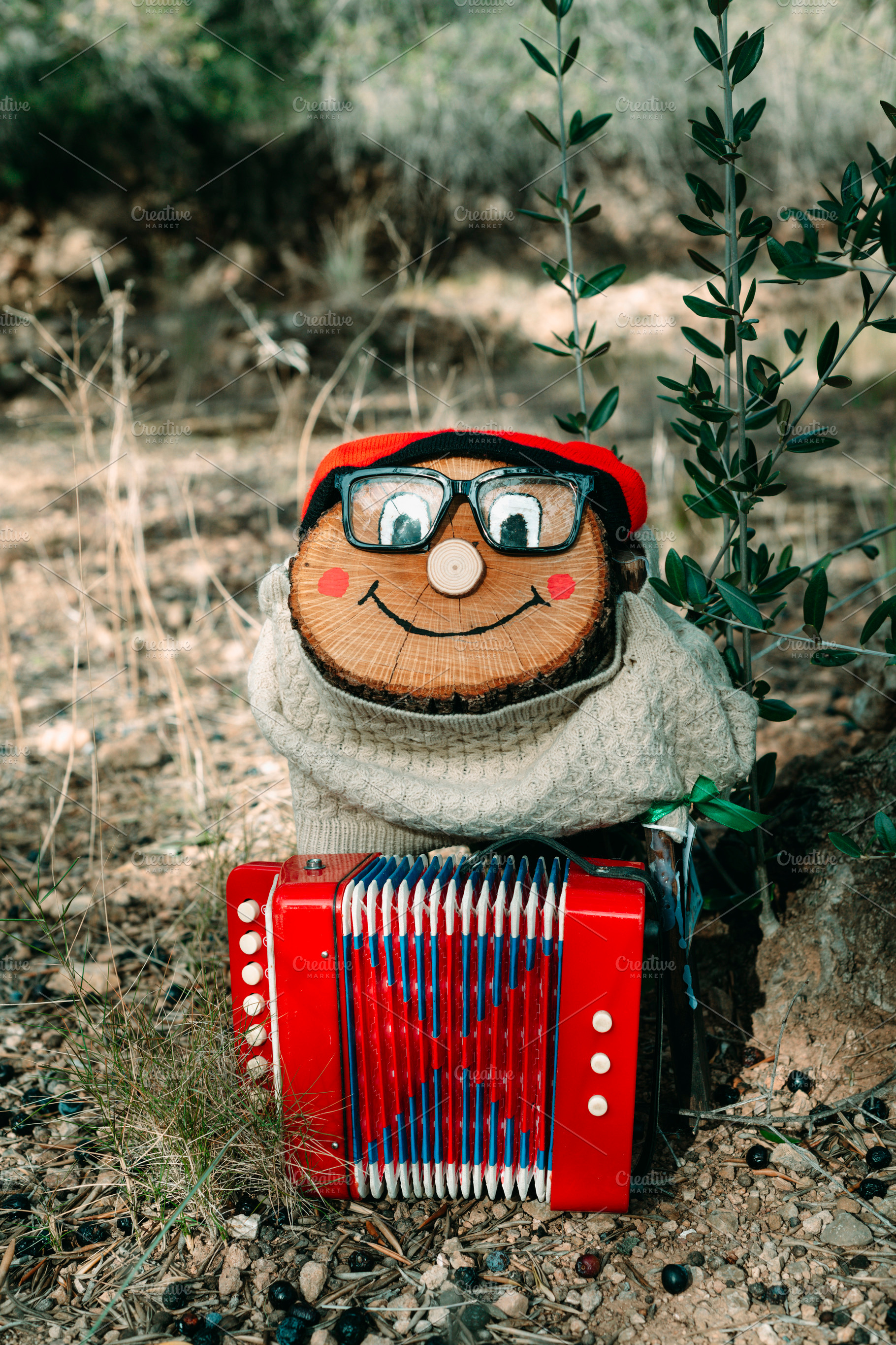 a Tio de Nadal standing with a red accordion, a Photo by Nito