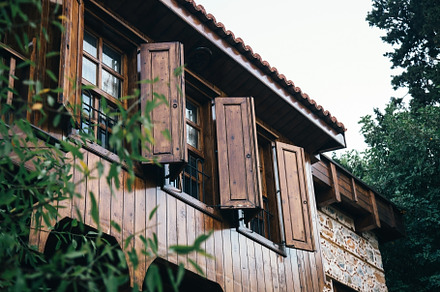 open wooden shutters on wooden windows in a Turkish house., an Architecture Photo by TanaCh