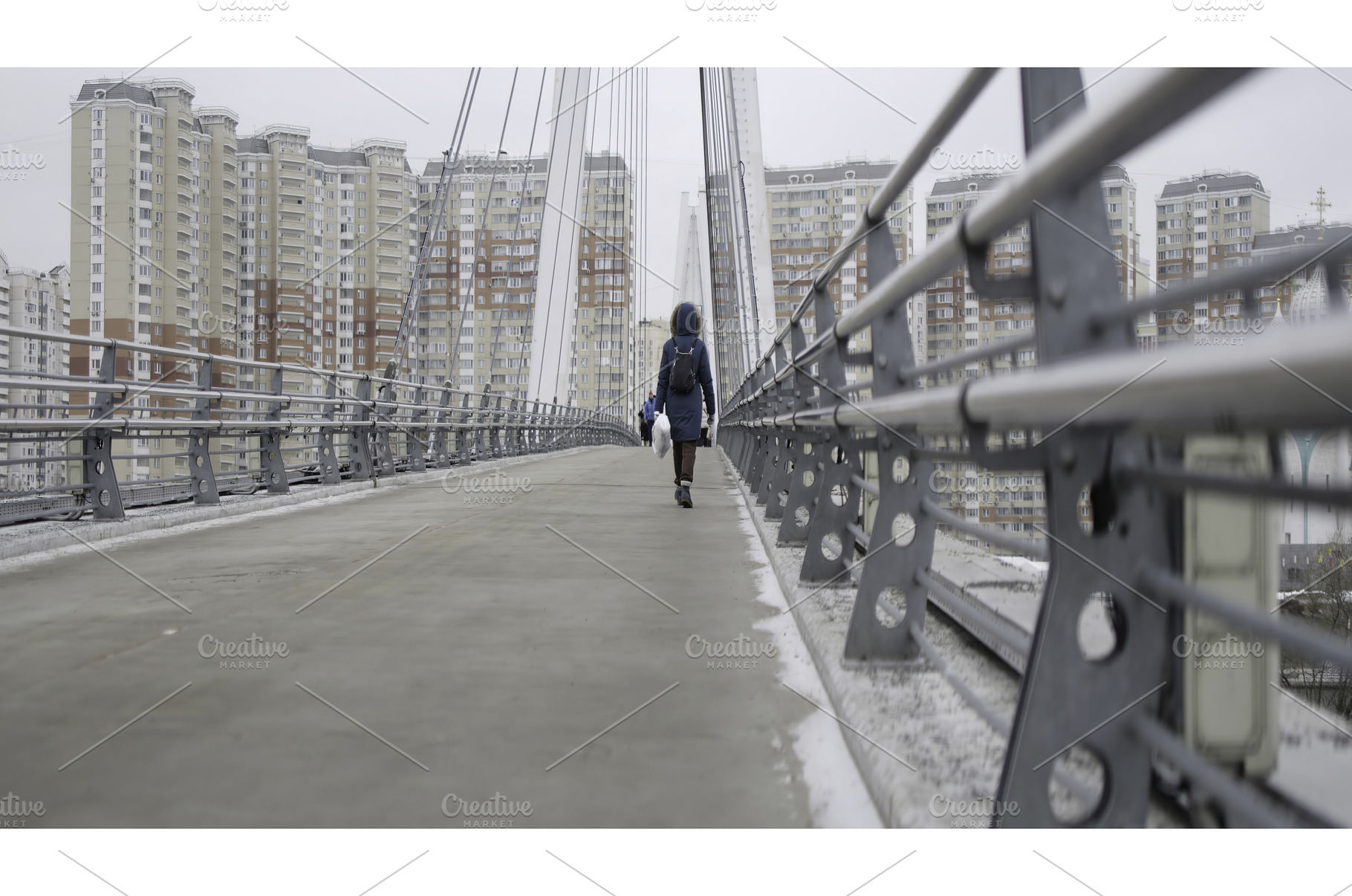 Woman walking on a cable stayed, an Architecture Photo by Media Whale Stock