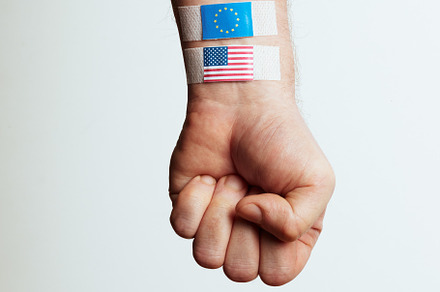 Fist Wrapped with USA and EU Flag Bandages, a Business Photo by Alliance Images