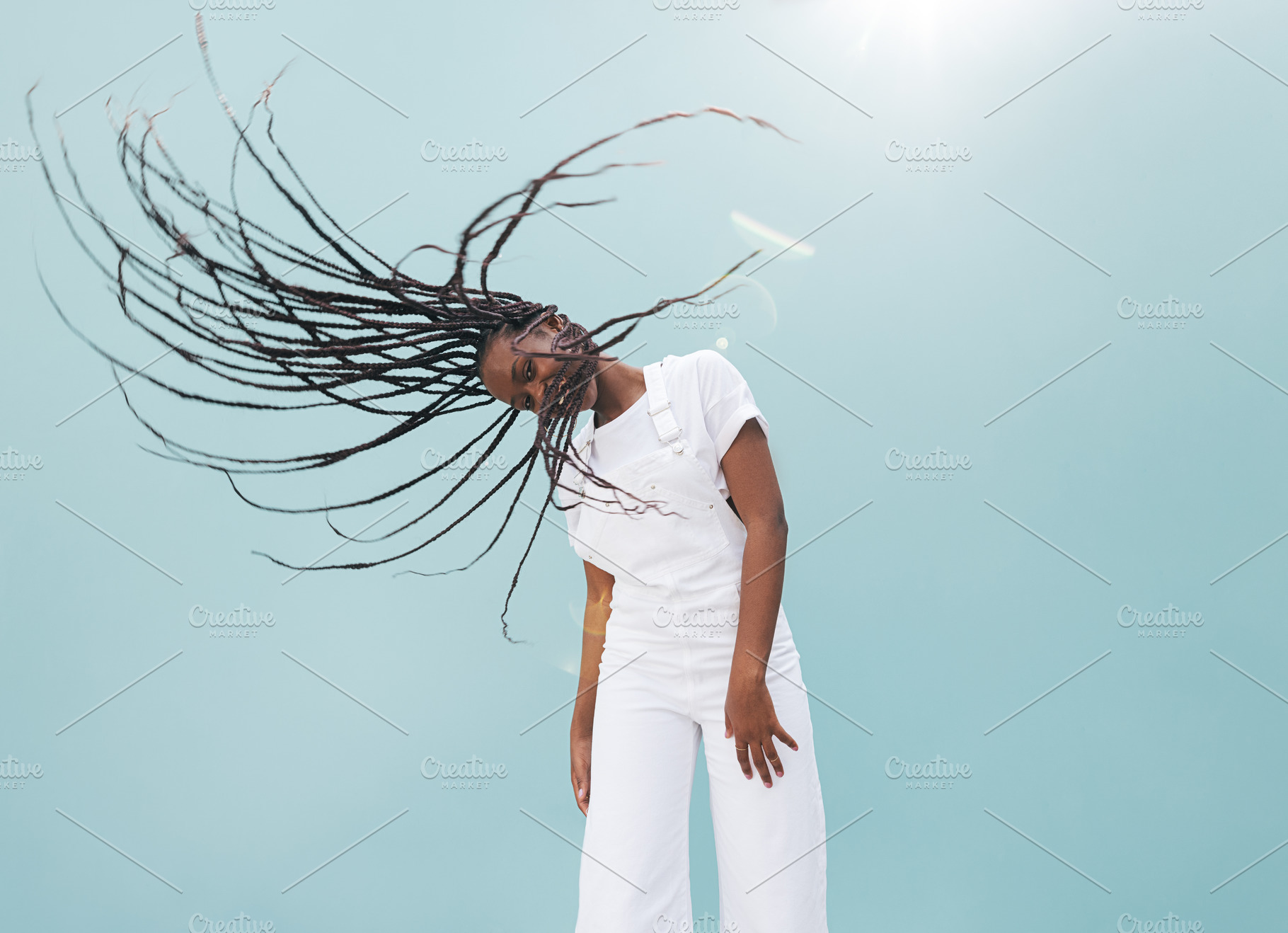 Young female waving her long braids, a Person Photo by Artem Varnitsin
