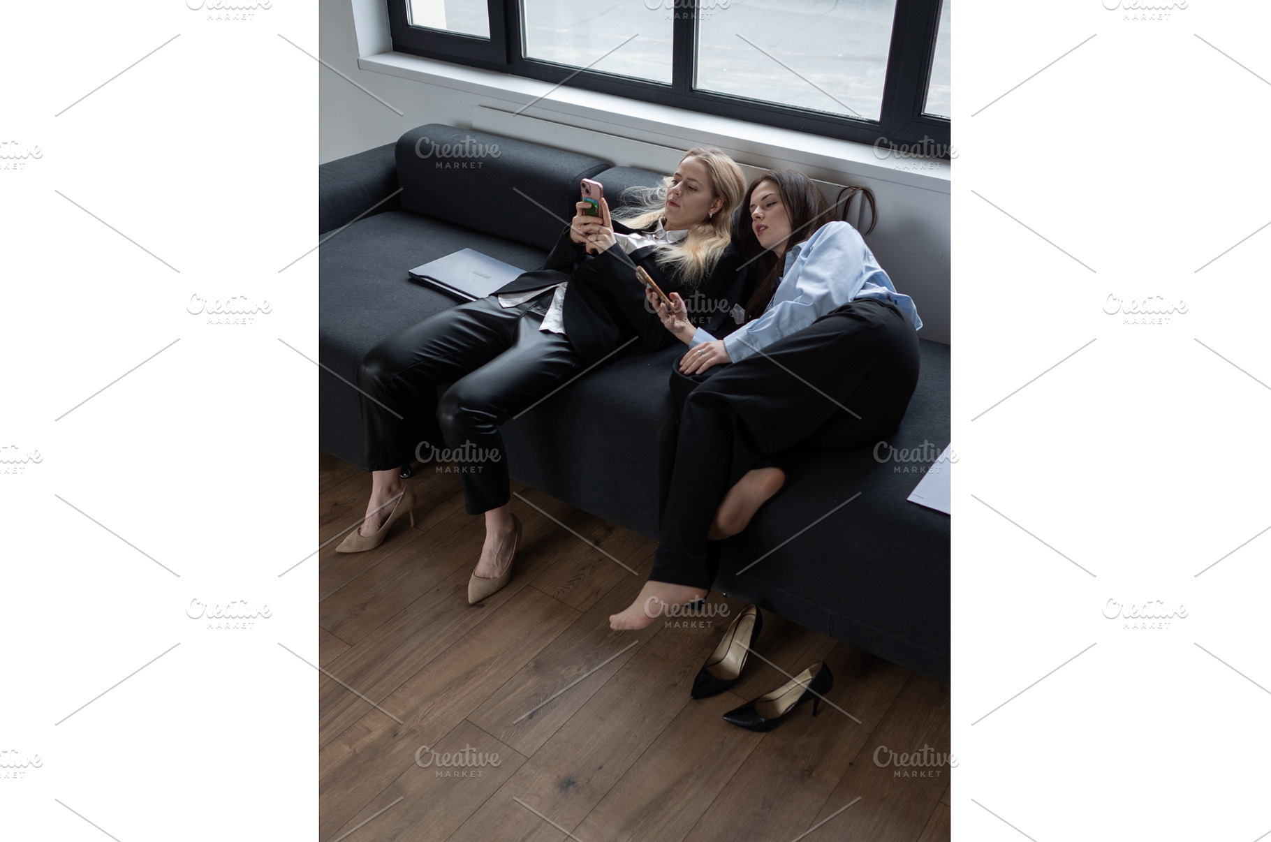 Two tired office women resting on, a Person Photo by undrey