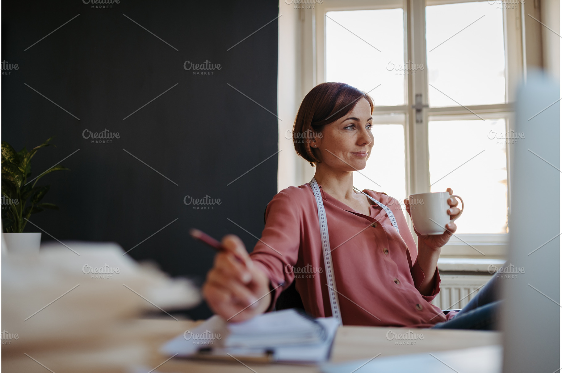 Female designer having coffee break, a Beauty & Fashion Photo by HalfPoint