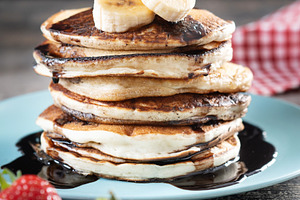 Pancakes with chocolate and fruit on wooden table, a Food & Drink Photo by etorres69