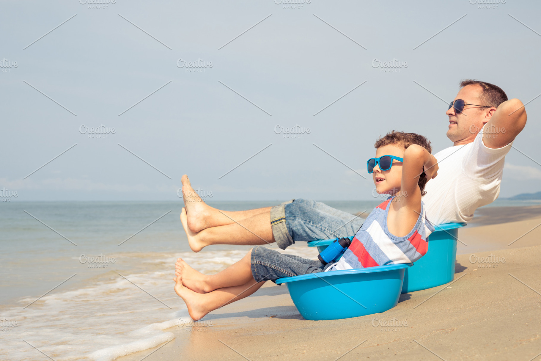 Father and son  playing on the beach stock photo containing cruise and fun, a Health & Medical Photo by altanaka