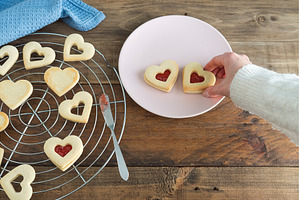 Woman's hand placing heart shaped