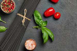 Black spaghetti, sprig of fresh basil, cherry tomatoes, pepper m, a Food & Drink Photo by ndanko