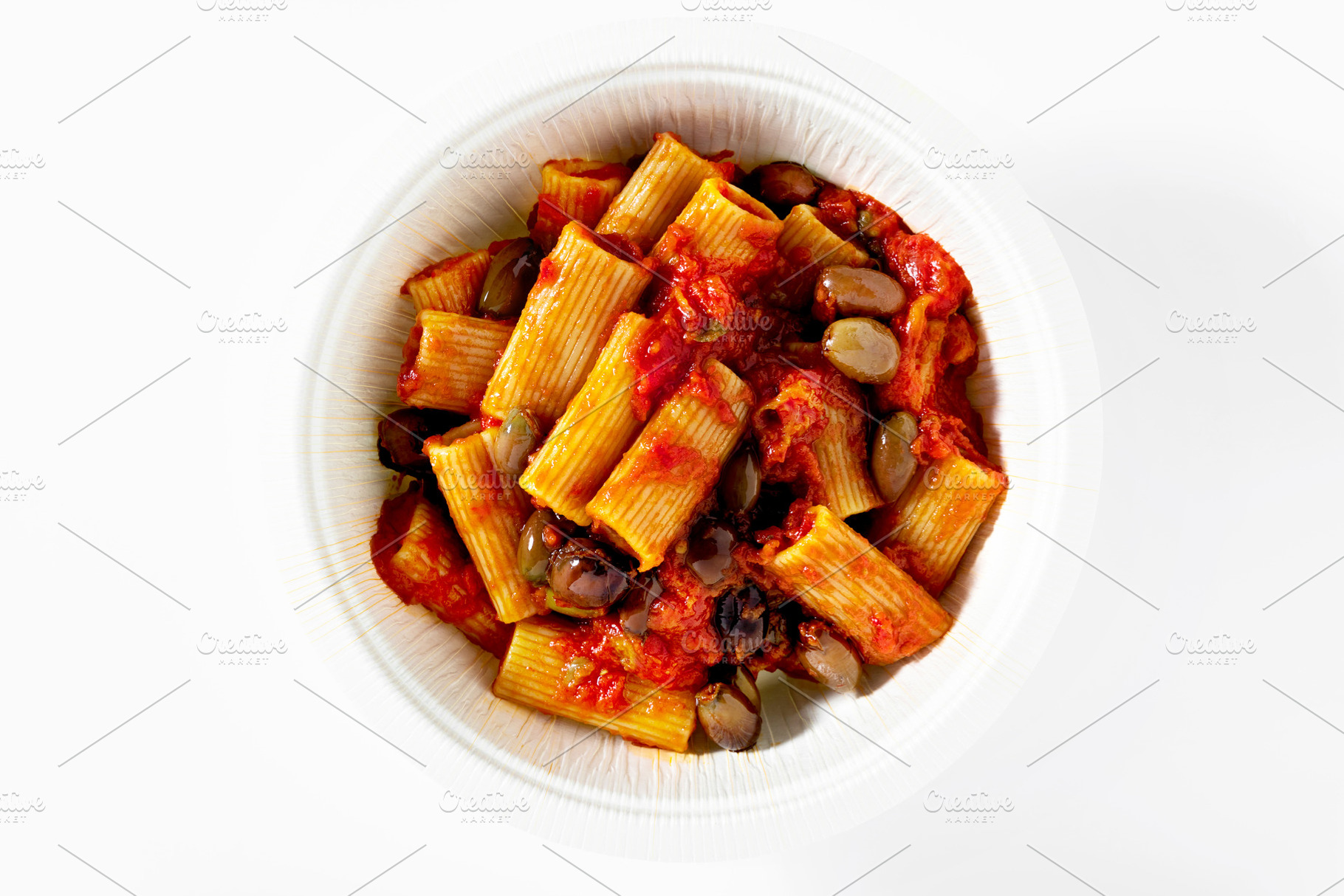 Italian tortiglioni pasta puttanesca with tomato sauce and black, a Food & Drink Photo by IriGri