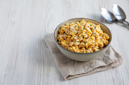 Homemade Slow Cooker Creamed Corn in a Bowl, side view. Copy spa, a Food & Drink Photo by LiudmylaChuhunova