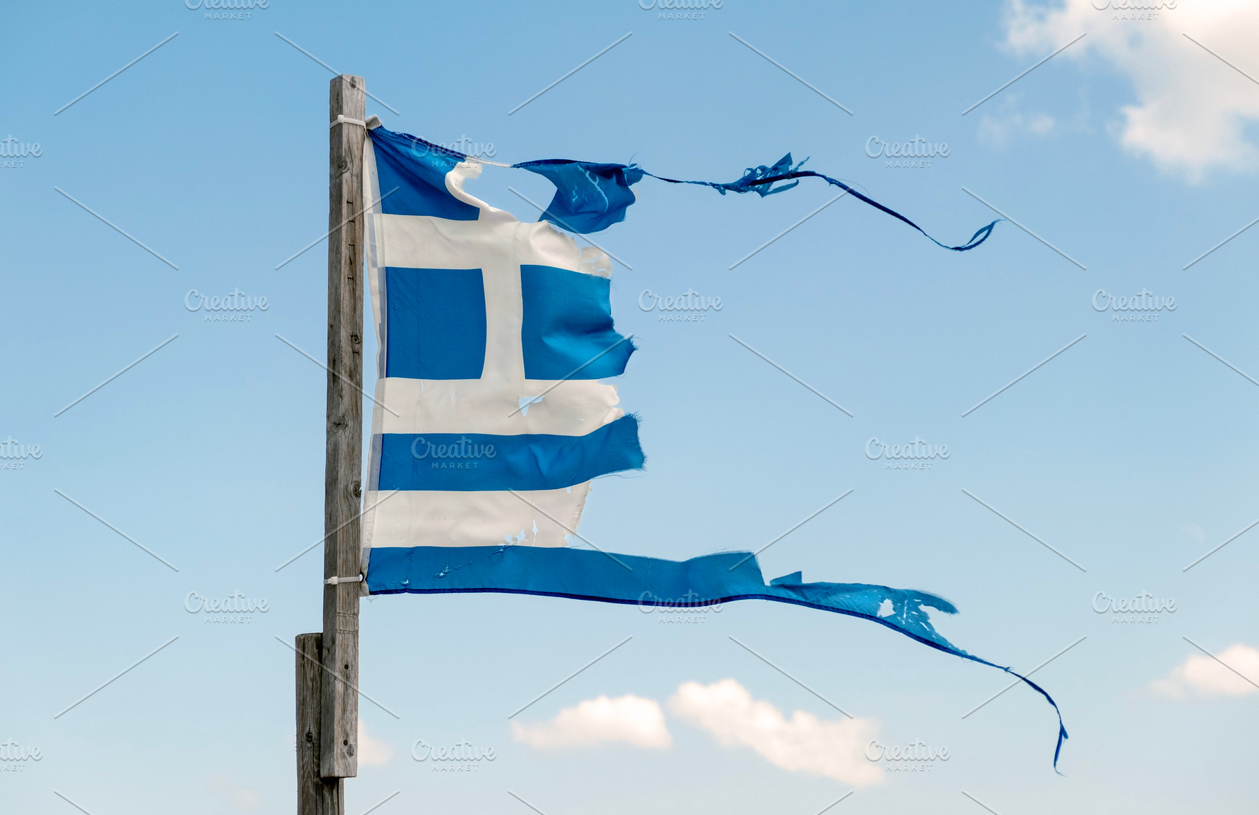 Old torn Greek flag waving, an Abstract Photo by BOOCYS