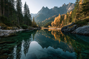 Lake mirrors trees and rocks, a Photo by Beautiful things
