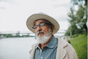 Pensive senior man looking at river., a Person Photo by HalfPoint