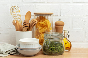 Kitchen utensils, pasta, mung beans, and oil creating a cozy cul, a Food & Drink Photo by Olena Rudo