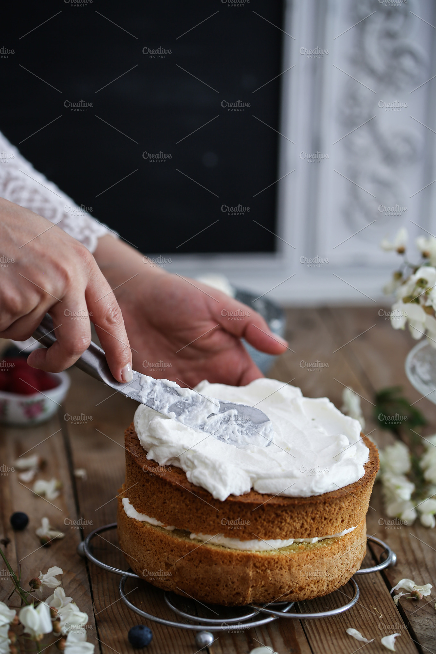 Woman frosting a cake, a Food & Drink Photo by The Little Wild Apple
