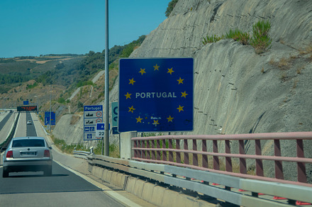 Cars entering portugal on highway bridge