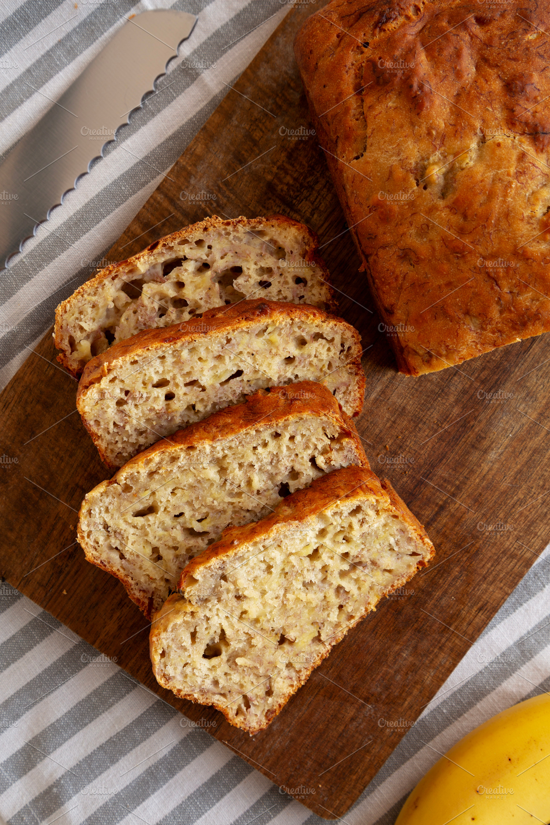 Homemade Banana Bread on a wooden board, top view. Close-up., a Food & Drink Photo by LiudmylaChuhunova