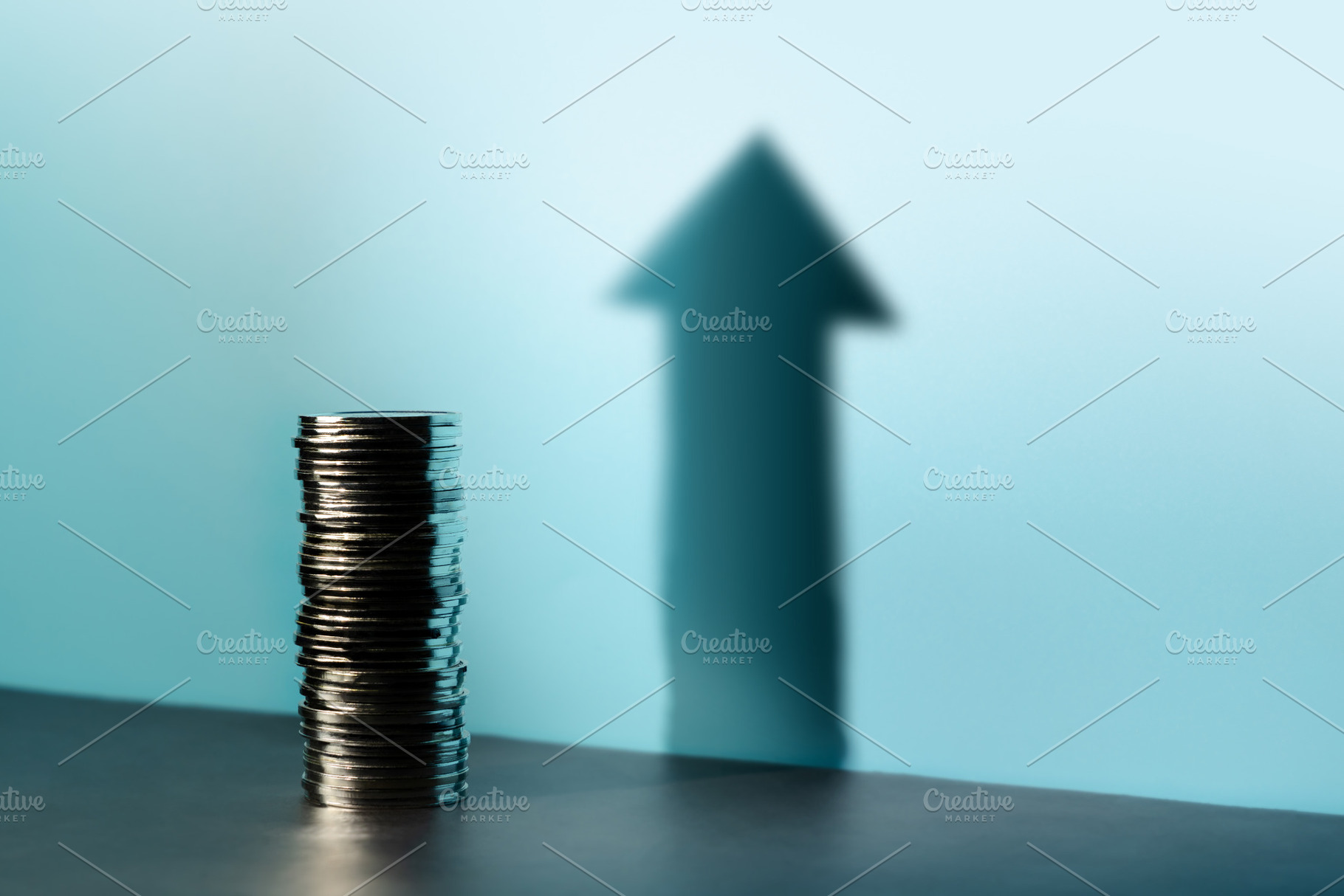 Coins stacked cast a tall upward arrow shadow, reflecting financ, a Photo by salmon.black