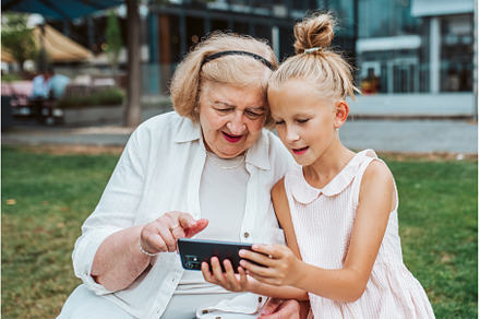 Grandma picking up young girl from