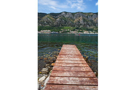 Long wooden pier against the, a Nature Photo by Artsaba Family
