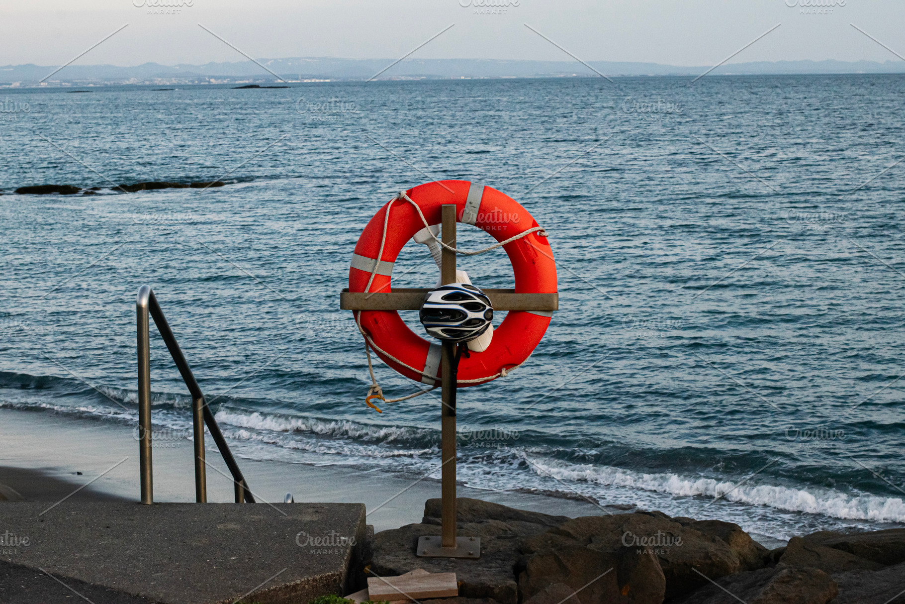 Lifesaver ring and helmet view near coastal area in Akranes, Iceland, a Photo by AS photostudio