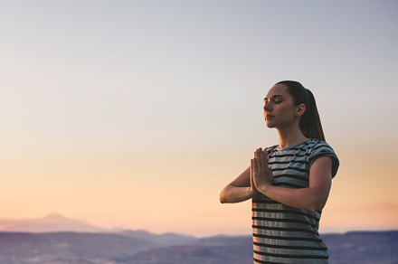 A girl practices yoga or meditation.