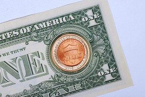 Dollar bill with one cent coin, a Business Photo by Ungvar Studio