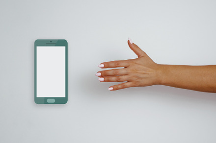 Woman's hand reaches for cell phone featuring female, mobile, and phone