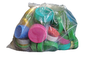 Plastic caps in transparent bag isolated photo, an Industrial Photo by DanFLCreativo