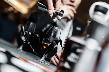 Bartender pours whiskey for tasting.