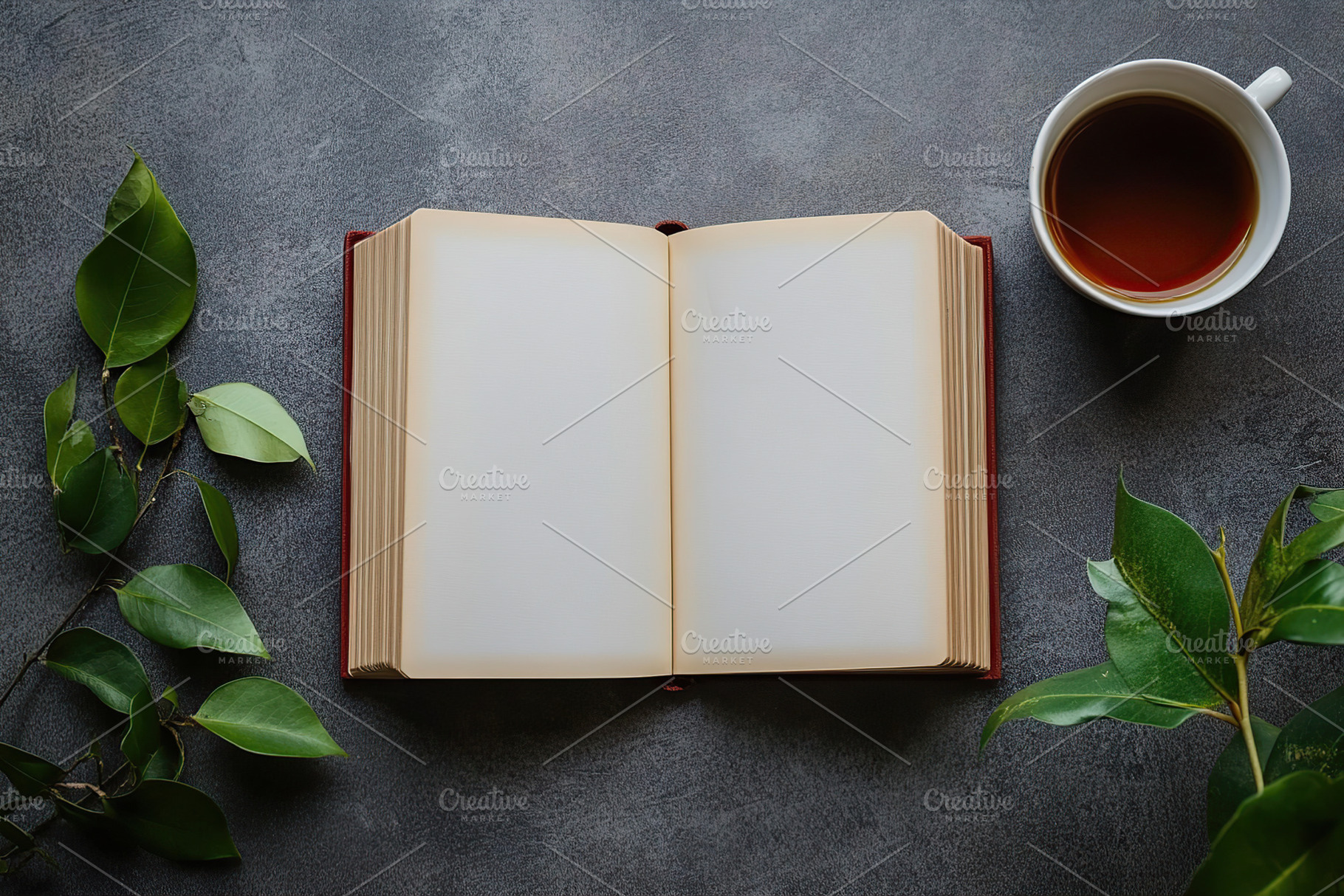 Open book with blank pages beside a cup of tea and green leaves on a gray surfa, a Background Photo by AlyaAnd