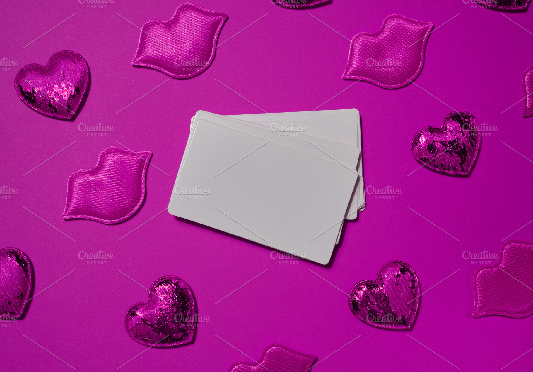 Set of blank white business cards surrounded by pink decorative, a Holiday Photo by ndanko